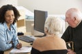 Young female Doctor talking to senior couple Royalty Free Stock Photo