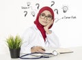 Doctor thinking her vision and career path while sitting at her table Royalty Free Stock Photo