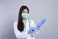Female doctor wearing blue surgical gloves