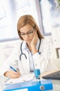 Young female doctor working at desk Royalty Free Stock Photo