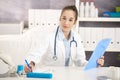 Young female doctor working at desk Royalty Free Stock Photo