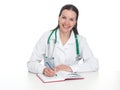 Young female doctor working at office desk and smiling Royalty Free Stock Photo