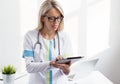 Young female doctor working with tablet computer Royalty Free Stock Photo