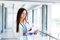 Young female doctor writes on paperboard Royalty Free Stock Photo