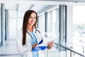 Young female doctor writes on paperboard Royalty Free Stock Photo