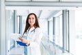 Young female doctor writes on paperboard Royalty Free Stock Photo