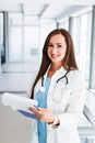 Young female doctor writes on paperboard Royalty Free Stock Photo