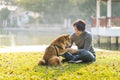 Young female and dog summer concept. The girl plays with the Shiba Inu dog in the backyard. Asian women are teaching and training