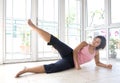 Young female doing leg raises as part of exercise