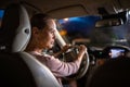 Young female driver driving her car at night Royalty Free Stock Photo