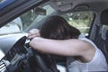 Young female driver at the wheel of her car, very tired, falling asleep while driving in a potentially dangerous situation - Road Royalty Free Stock Photo