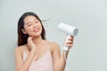 Young female drying her beautiful hair with hairdryer Royalty Free Stock Photo