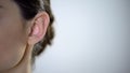 Young female ear closeup, useless rumors and disinformation, privacy intrusion Royalty Free Stock Photo