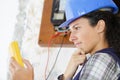 young female electrician alalysing results on multimeter Royalty Free Stock Photo