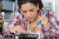 Young female electronic engineer soldering computer parts Royalty Free Stock Photo