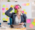 Young female employee in conflicting priorities concept Royalty Free Stock Photo