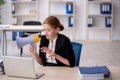 Young female employee holding megaphone in the office Royalty Free Stock Photo