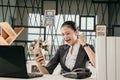 Young female employee sit at office desks looking at smartphones at work Royalty Free Stock Photo