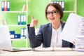 The young female employee very busy with ongoing paperwork Royalty Free Stock Photo
