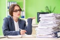 The young female employee very busy with ongoing paperwork Royalty Free Stock Photo