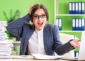 Young female employee very busy with ongoing paperwork Royalty Free Stock Photo