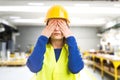 Young female engineer covering her eyes Royalty Free Stock Photo