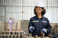 A young female engineer inspects and repairs parts of a robotic welding machine Royalty Free Stock Photo