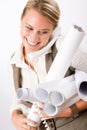 Young female engineer on phone carry blueprints Royalty Free Stock Photo