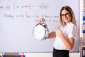 The young female english language teacher standing in front of the blackboard Royalty Free Stock Photo