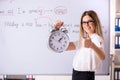 The young female english language teacher standing in front of the blackboard Royalty Free Stock Photo