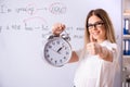 The young female english language teacher standing in front of the blackboard Royalty Free Stock Photo