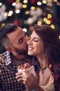 Female enjoy in kiss and gift for Christmas