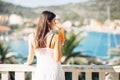 Young female enjoying a colourful cocktail on the panoramic view hotel terrace.Cold delicious cocktail smoothie