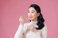 Young female enjoying taste of yogurt isolated on pink Royalty Free Stock Photo