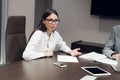 Young female executive smiling during meeting in office conference room