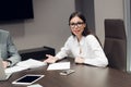 Young female executive smiling during meeting in office conference room Royalty Free Stock Photo