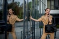 Young female executive standing outside office building talking on cell phone. Caucacian businesswoman making a phone call while Royalty Free Stock Photo