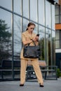 Young female executive standing outside office building talking on cell phone. Caucacian businesswoman making a phone call while Royalty Free Stock Photo