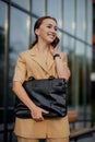 Young female executive standing outside office building talking on cell phone. Caucacian businesswoman making a phone call while Royalty Free Stock Photo