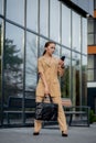 Young female executive standing outside office building talking on cell phone. Caucacian businesswoman making a phone Royalty Free Stock Photo