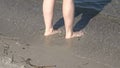 Young female feet walking in the shallow water at a baltic sea beach in summer Royalty Free Stock Photo