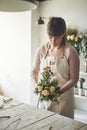 Young female florist making a flower bouquet in her workshop Royalty Free Stock Photo