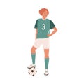 Young female football or soccer player standing with caught ball under her foot. Woman wearing green sports outfit Royalty Free Stock Photo