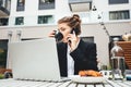 Young female freelancer have conversation on telephone with customer at coffee shop