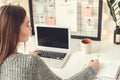 Young woman freelancer indoors home office concept winter atmosphere sitting taking notes Royalty Free Stock Photo