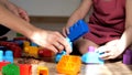 Girl busy with his building constructor bricks. Happy family playing educational toys at home Royalty Free Stock Photo