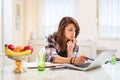 Young female freelancer working at creative project on her laptop at home. Royalty Free Stock Photo