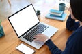 A young female freelancer working with laptop computer at her workspace. Royalty Free Stock Photo