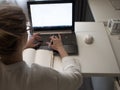 Young female freelancer works remotely. Setting up a workplace.