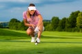 Young female golf player on course aiming for her put Royalty Free Stock Photo